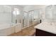 Bright bathroom featuring a soaking tub and walk-in shower at 43525 W Cydnee Dr, Maricopa, AZ 85138