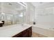 Bright bathroom featuring a large vanity, soaking tub, and tiled floors at 43525 W Cydnee Dr, Maricopa, AZ 85138