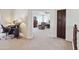 Bright bedroom featuring a comfortable workstation and relaxation area with a cozy recliner at 43525 W Cydnee Dr, Maricopa, AZ 85138