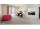 Bonus room features neutral carpet, big window, desk area, and pink beanbag chair at 43525 W Cydnee Dr, Maricopa, AZ 85138