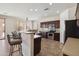 Well-equipped kitchen featuring dark wood cabinetry, a breakfast bar, and stainless steel appliances at 43525 W Cydnee Dr, Maricopa, AZ 85138