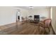 Spacious living room with wood-look tile, features lots of natural light and neutral color palette at 43525 W Cydnee Dr, Maricopa, AZ 85138