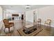 Open-concept living room with wood look floors, neutral paint, and elegant rug and coffee table at 43525 W Cydnee Dr, Maricopa, AZ 85138