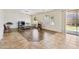 Bright Gathering room featuring wood-look tile flooring, media center, and large sliding glass doors at 43525 W Cydnee Dr, Maricopa, AZ 85138