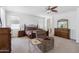 Spacious primary bedroom with a cozy chair and beautiful decor at 43525 W Cydnee Dr, Maricopa, AZ 85138