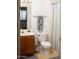 Cozy bathroom includes a wood vanity, a toilet and a shower-tub with a decorative curtain at 455 S Mesa Dr # 104, Mesa, AZ 85210
