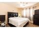 Spacious bedroom with a dark bed and side tables at 455 S Mesa Dr # 104, Mesa, AZ 85210