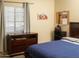 Comfortable bedroom featuring wood furniture, natural light, and a peaceful ambiance for relaxation at 455 S Mesa Dr # 104, Mesa, AZ 85210