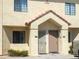 Exterior view of a townhouse with tan stucco, a red tile roof, and unit numbers 103 and 104 at 455 S Mesa Dr # 104, Mesa, AZ 85210