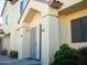 Exterior view of townhouse shows stucco, red tile roof, and unit numbers 103 and 104 at 455 S Mesa Dr # 104, Mesa, AZ 85210