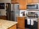 Updated kitchen with granite countertops, stainless steel appliances, and wood cabinets at 455 S Mesa Dr # 104, Mesa, AZ 85210