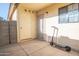 Enclosed outdoor patio with access doors and a scooter parked on the concrete at 455 S Mesa Dr # 104, Mesa, AZ 85210