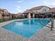Relaxing community pool with a gazebo, set amongst landscaped grounds and wrought iron fencing at 455 S Mesa Dr # 104, Mesa, AZ 85210