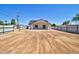 Wide shot of the property's back yard with dirt landscaping at 461 W Lindbergh Ave, Coolidge, AZ 85128