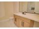 Bathroom showcasing a vanity with light wood cabinets, silver hardware, a large mirror, and white countertop at 461 W Lindbergh Ave, Coolidge, AZ 85128
