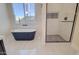 Luxurious bathroom features a modern soaking tub and a frameless glass shower with accent tiles and modern fixtures at 461 W Lindbergh Ave, Coolidge, AZ 85128