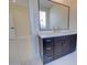 Bathroom showcasing a vanity with dark cabinets, gold hardware, a large mirror, and white countertop at 461 W Lindbergh Ave, Coolidge, AZ 85128