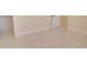 Neutral colored bedroom with sleek tile flooring and white baseboards at 461 W Lindbergh Ave, Coolidge, AZ 85128