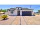 Charming home with a well-maintained yard, attractive landscaping, and a two car garage at 461 W Lindbergh Ave, Coolidge, AZ 85128
