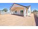 Home's back exterior showcasing a covered patio and gravel landscaping at 461 W Lindbergh Ave, Coolidge, AZ 85128