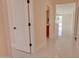 Bright hallway with white doors, neutral paint and tile floor at 461 W Lindbergh Ave, Coolidge, AZ 85128