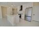 Modern kitchen featuring white cabinets, stainless steel appliances, and a sleek island at 461 W Lindbergh Ave, Coolidge, AZ 85128
