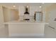 Modern kitchen featuring white cabinets, stainless steel appliances, and a sleek island at 461 W Lindbergh Ave, Coolidge, AZ 85128