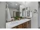 Elegant bathroom featuring double sinks, decorative mirrors, and neutral tile at 4777 S Fulton Ranch Blvd # 2071, Chandler, AZ 85248