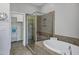 Relaxing bathroom with a soaking tub, glass shower, and convenient walk-in closet access at 4777 S Fulton Ranch Blvd # 2071, Chandler, AZ 85248