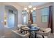 Neutral tone dining room featuring chandelier, round table set for four, and arched doorways at 4777 S Fulton Ranch Blvd # 2071, Chandler, AZ 85248