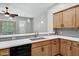 Contemporary kitchen highlighting white countertops, wood cabinets, and stainless steel sink at 4777 S Fulton Ranch Blvd # 2071, Chandler, AZ 85248