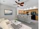 Open-concept living space features a cozy seating area and adjacent kitchen with bar seating at 4777 S Fulton Ranch Blvd # 2071, Chandler, AZ 85248