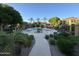Community pool featuring lounge chairs, shade structures, and lush landscaping at 4777 S Fulton Ranch Blvd # 2071, Chandler, AZ 85248