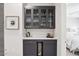Elegant bar area with glass cabinets, wine cooler, and stylish countertop is perfect for entertaining guests at 5250 E Deer Valley Dr # 247, Phoenix, AZ 85054
