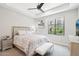 Well-lit bedroom boasts a ceiling fan, tray ceiling, and a large window at 5250 E Deer Valley Dr # 247, Phoenix, AZ 85054