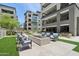 Outdoor lounge area with modern seating, fire pit, and lush landscaping for social gatherings at 5250 E Deer Valley Dr # 247, Phoenix, AZ 85054