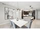 Bright dining room featuring a modern chandelier, view into the kitchen, and seating for six at 5250 E Deer Valley Dr # 247, Phoenix, AZ 85054