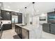 Well-lit kitchen with a center island, pendant lights, and modern stainless steel appliances at 5250 E Deer Valley Dr # 247, Phoenix, AZ 85054