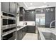 Stylish kitchen featuring stainless steel appliances, ample cabinetry, and quartz countertops at 5250 E Deer Valley Dr # 247, Phoenix, AZ 85054