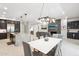 Open-concept living area featuring a modern kitchen island, dining table, and a cozy living room space at 5250 E Deer Valley Dr # 247, Phoenix, AZ 85054