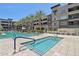 Modern apartment complex featuring a beautiful pool and spa surrounded by palm trees at 5250 E Deer Valley Dr # 247, Phoenix, AZ 85054