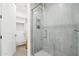 Modern shower with a glass enclosure, stone tile, and built-in product shelf at 5250 E Deer Valley Dr # 247, Phoenix, AZ 85054