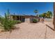 Charming home features a spacious backyard, lush trees, privacy fence, and covered patio, offering serene outdoor living at 5420 N Granite Reef Rd, Scottsdale, AZ 85250