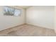 Bedroom with neutral carpet and a bright window overlooking foliage at 5420 N Granite Reef Rd, Scottsdale, AZ 85250