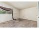 Bedroom with plush carpet and a bright window overlooking foliage at 5420 N Granite Reef Rd, Scottsdale, AZ 85250