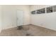 Bedroom with neutral carpet, window, and white door at 5420 N Granite Reef Rd, Scottsdale, AZ 85250