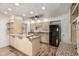 Well-lit kitchen featuring wood floors and granite countertops at 5420 N Granite Reef Rd, Scottsdale, AZ 85250