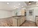 Open kitchen with granite countertops, modern appliances, and wood floors at 5420 N Granite Reef Rd, Scottsdale, AZ 85250