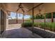 Covered patio with ceiling fans, lush plants, and an open space at 5420 N Granite Reef Rd, Scottsdale, AZ 85250
