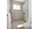 Contemporary bathroom showcases a walk-in shower with neutral tiling, a window, and sleek black hardware at 6835 E Friess Dr, Scottsdale, AZ 85254